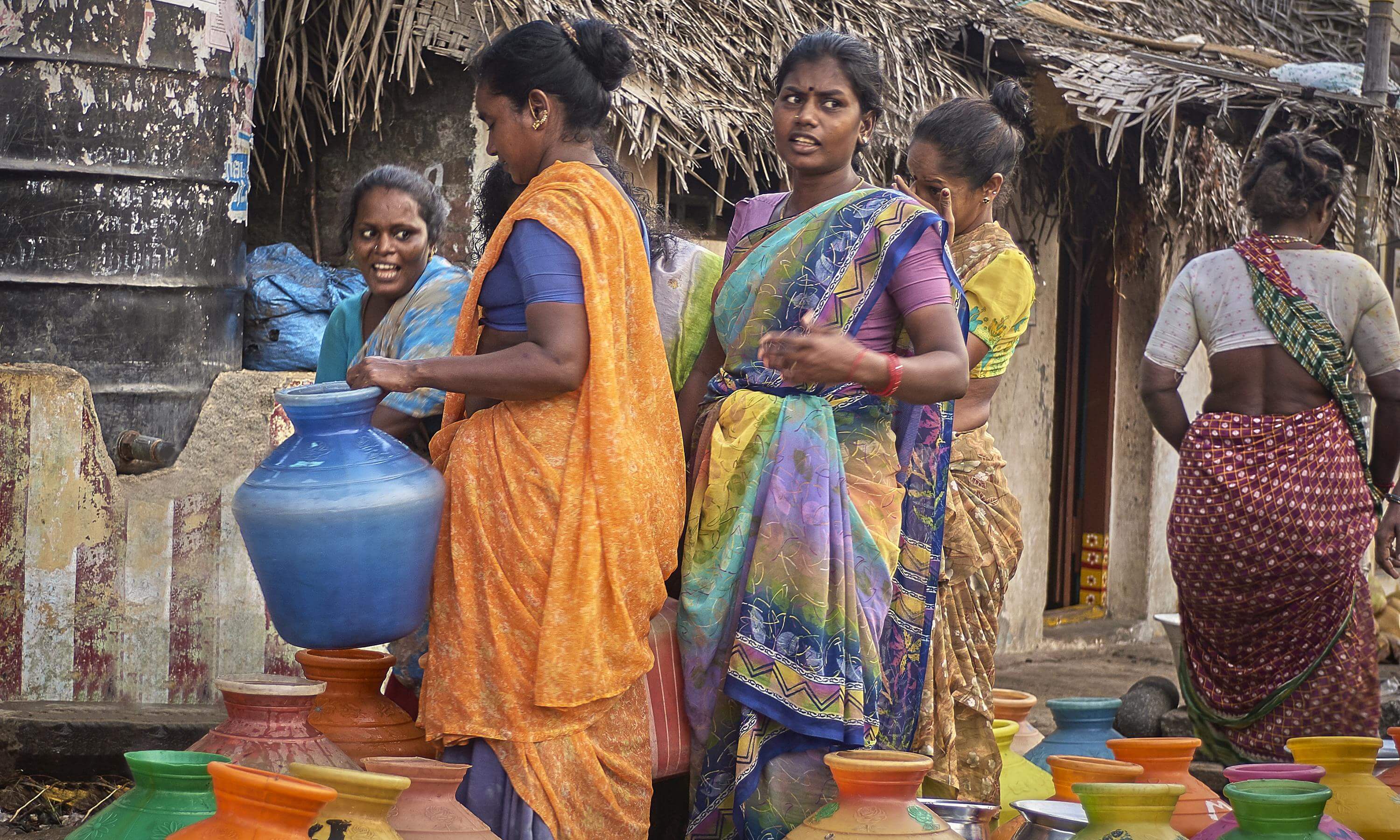 Indian women carry water in jugs