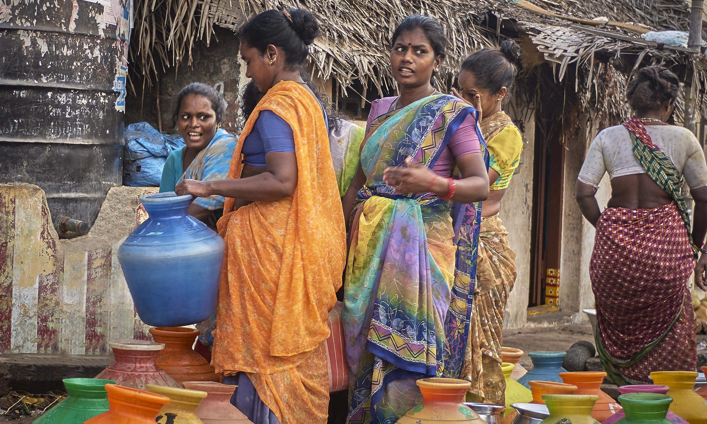 Indian women carry water in jugs