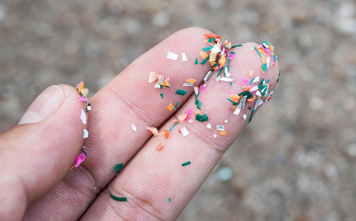 Close up of microplastic on fingers