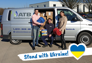 ATB employees stand in front of the company vehicle with donations in kind