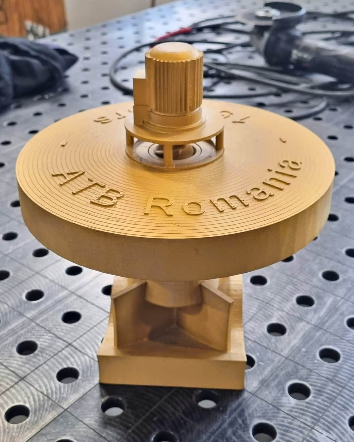 Golden miniature model of HSA surface aerator with ATB Romania lettering