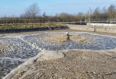 Surface aerator in operation in the aeration basin of a wastewater treatment plant