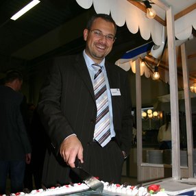 Inauguration ceremony of the converted company building. A cake in the foreground